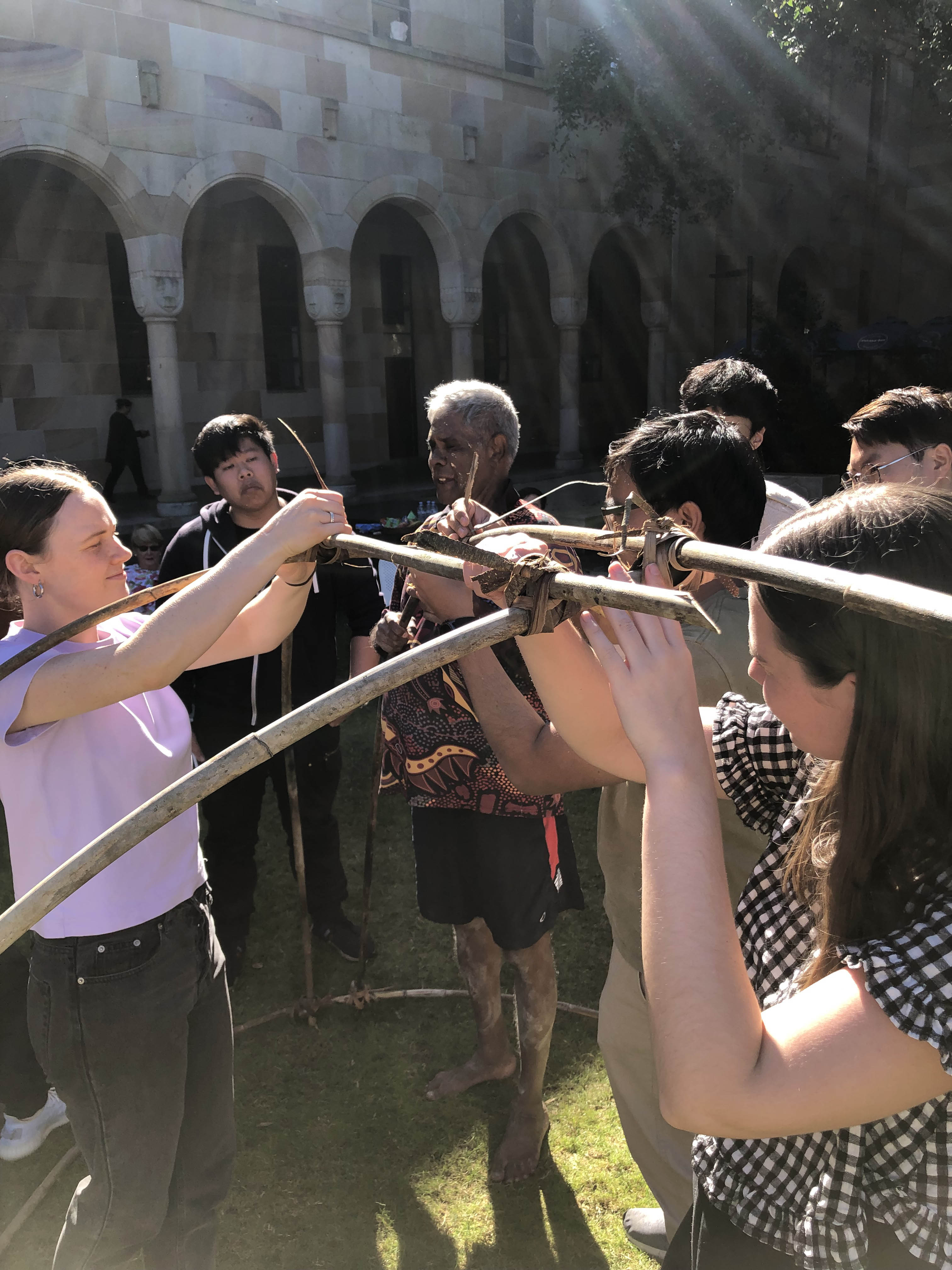 Students create a bulmba frame in the UQ Great Court