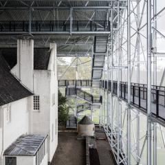 external scaffolded structure over existing brick building