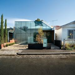Image of traditional timber house with modern glass structure addition